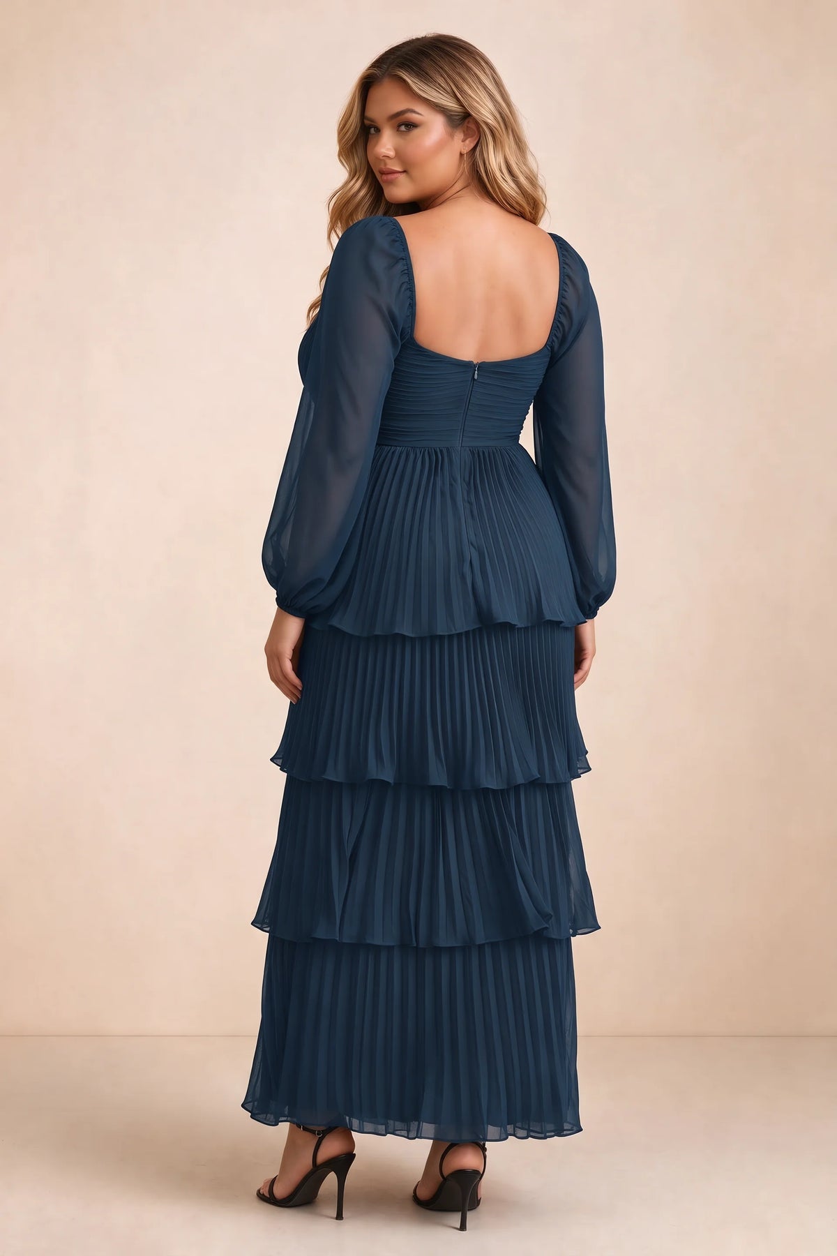 Rear view on a second model of Sienna navy tiered pleated maxi dress with a long flowing skirt