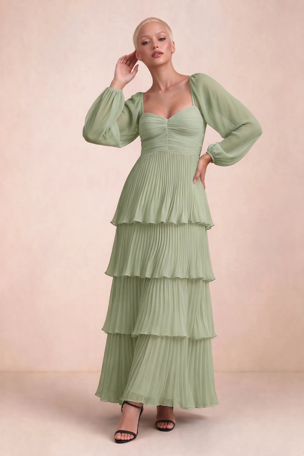 Front studio view of Sienna pistachio tiered pleated maxi dress with a long flowing skirt