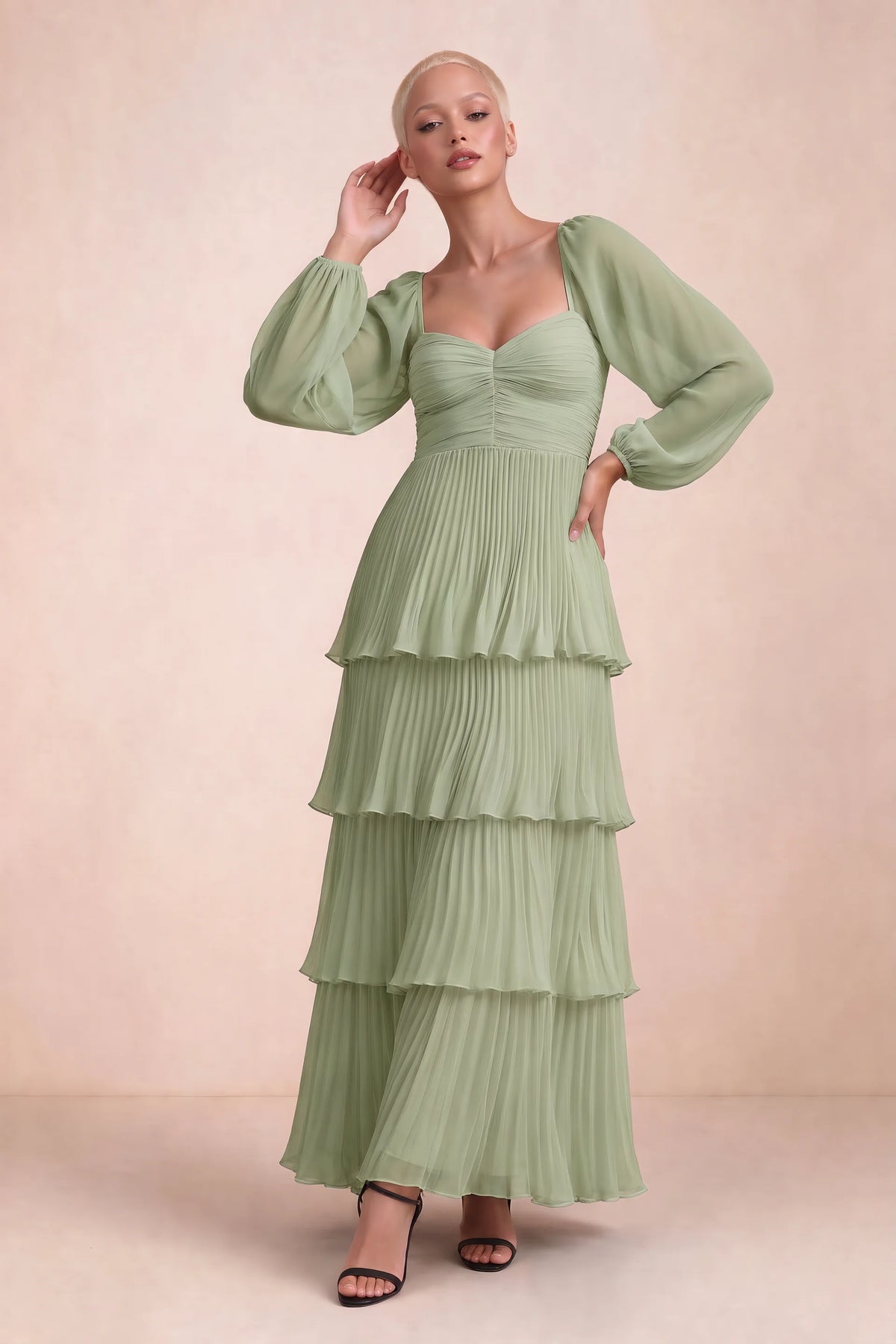 Front studio view of Sienna pistachio tiered pleated maxi dress with a long flowing skirt