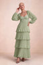Front studio view of Sienna pistachio tiered pleated maxi dress with a long flowing skirt