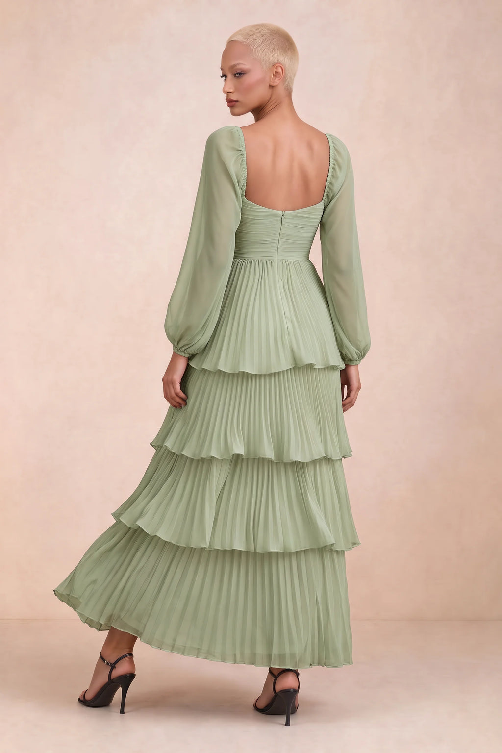 Rear studio view of Sienna pistachio tiered pleated maxi dress with a long flowing skirt