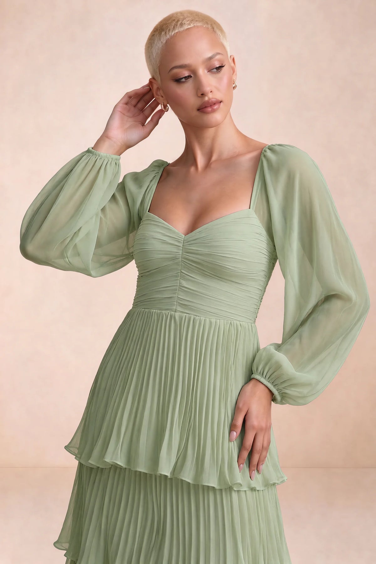 Close-up of sweetheart neckline, sheer sleeves and ruched waist of Sienna pistachio tiered pleated maxi dress