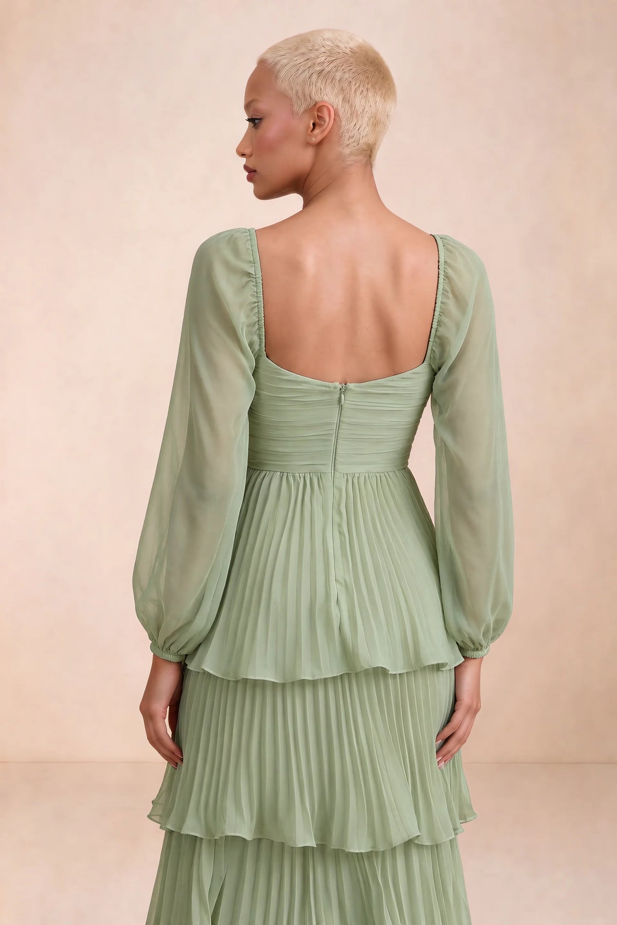 Close-up of low square back, sheer sleeves and centre-back zipper of Sienna pistachio tiered pleated maxi dress