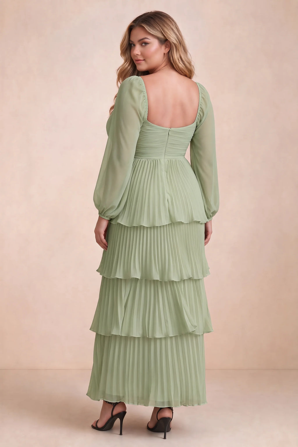 Rear view on a second model of Sienna pistachio tiered pleated maxi dress with a long flowing skirt