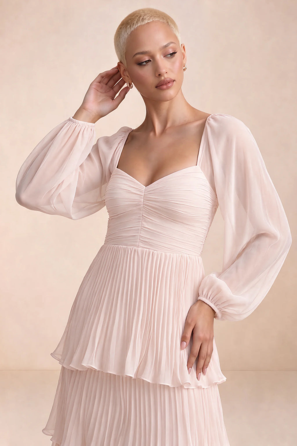 Close-up of sweetheart neckline, sheer sleeves and ruched waist of Sienna powder pink tiered pleated maxi dress
