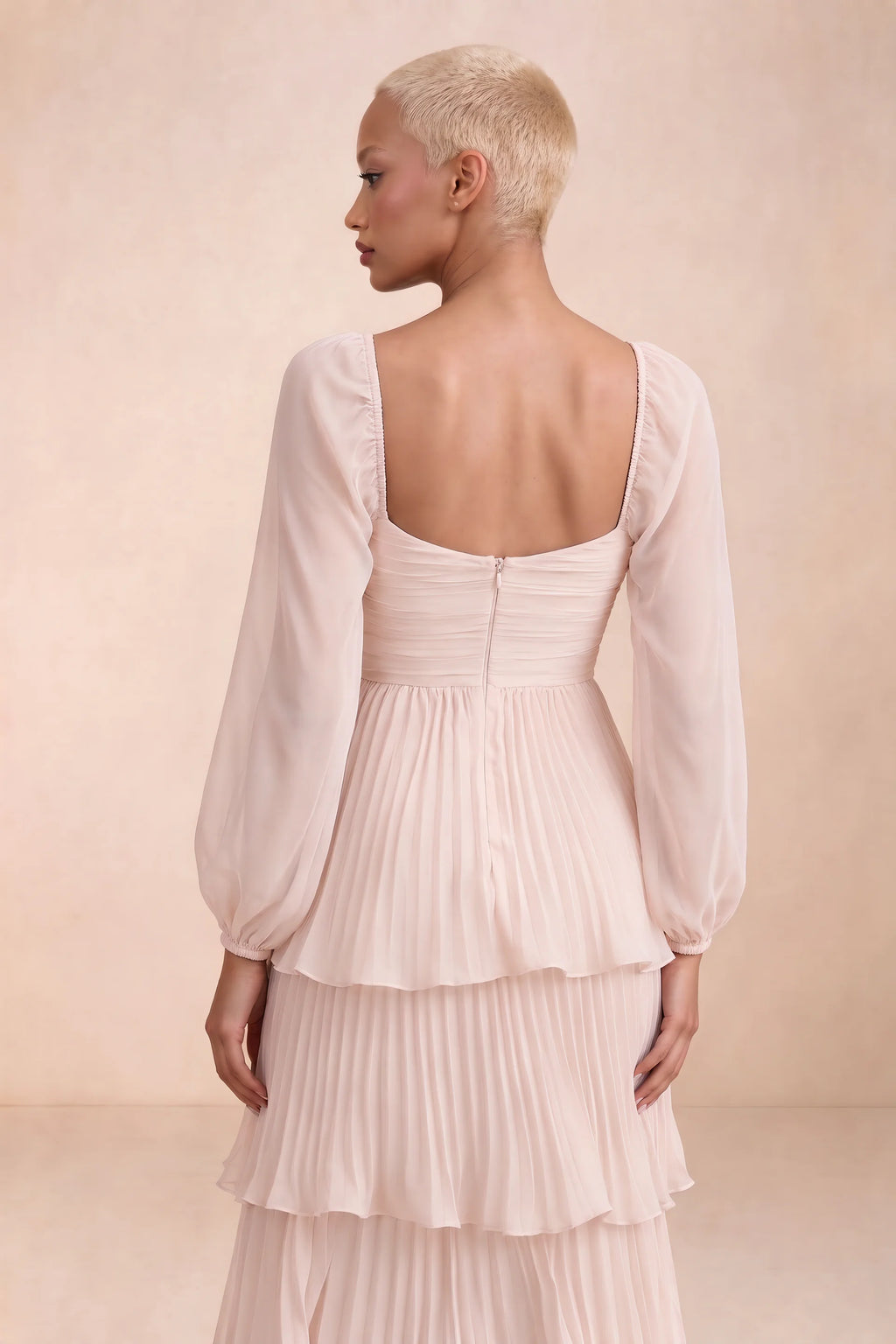 Close-up of low square back, sheer sleeves and centre-back zipper of Sienna powder pink tiered pleated maxi dress