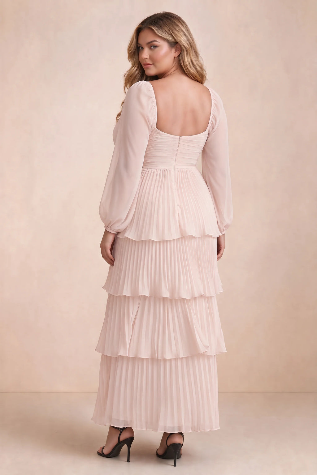 Rear view on a second model of Sienna powder pink tiered pleated maxi dress with a long flowing skirt