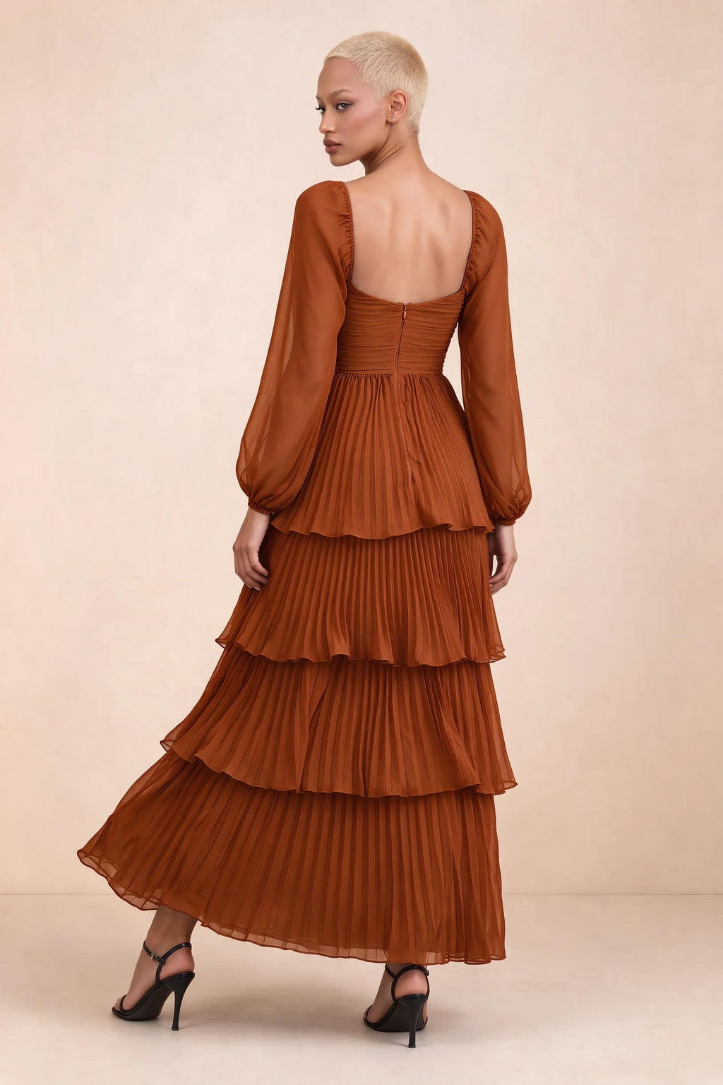 Rear studio view of Sienna rust tiered pleated maxi dress with a long flowing skirt