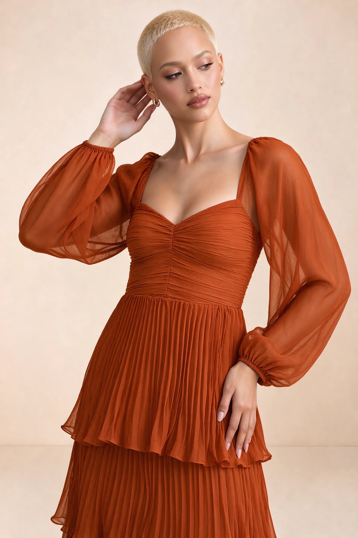 Close-up of sweetheart neckline, sheer sleeves and ruched waist of Sienna rust tiered pleated maxi dress