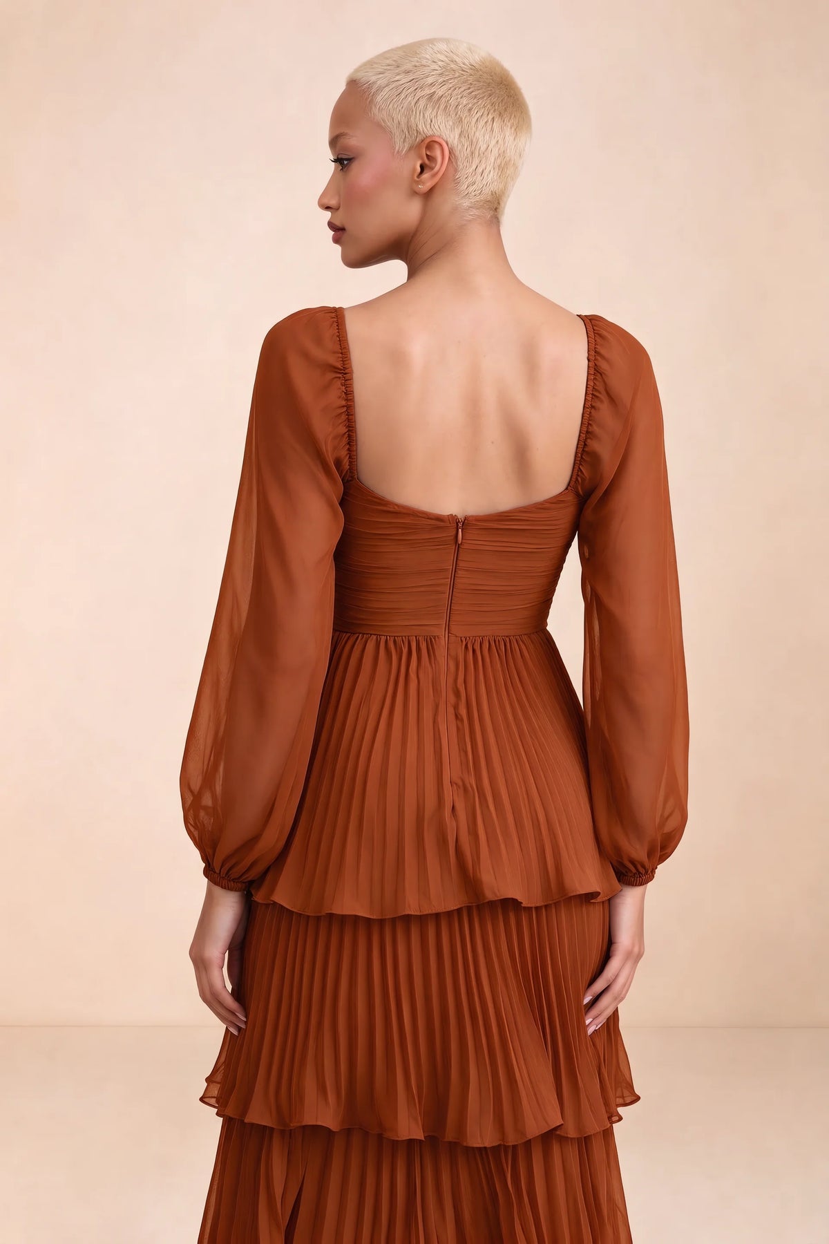 Close-up of low square back, sheer sleeves and centre-back zipper of Sienna rust tiered pleated maxi dress
