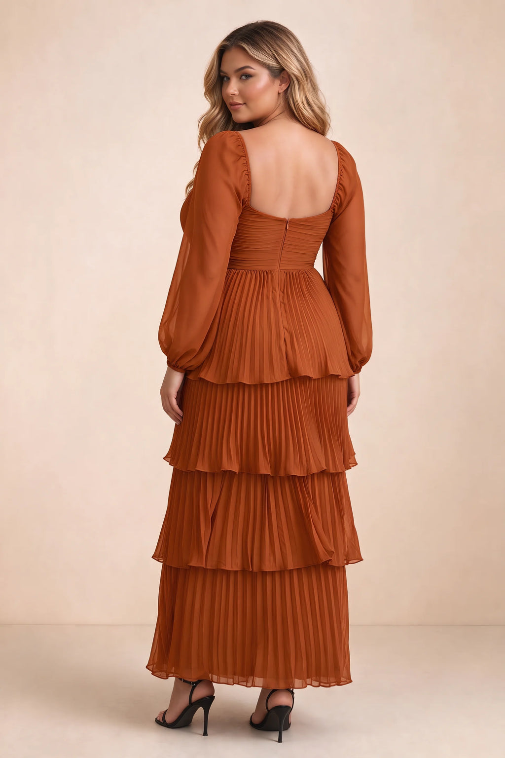 Rear view on a second model of Sienna rust tiered pleated maxi dress with a long flowing skirt