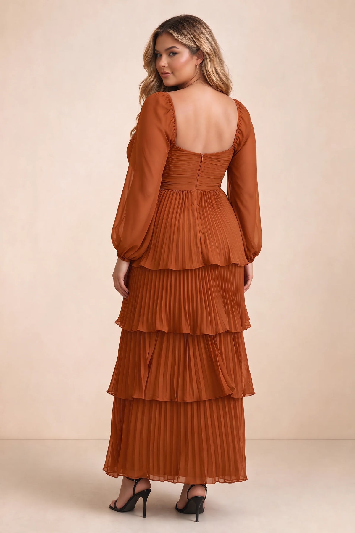 Rear view on a second model of Sienna rust tiered pleated maxi dress with a long flowing skirt
