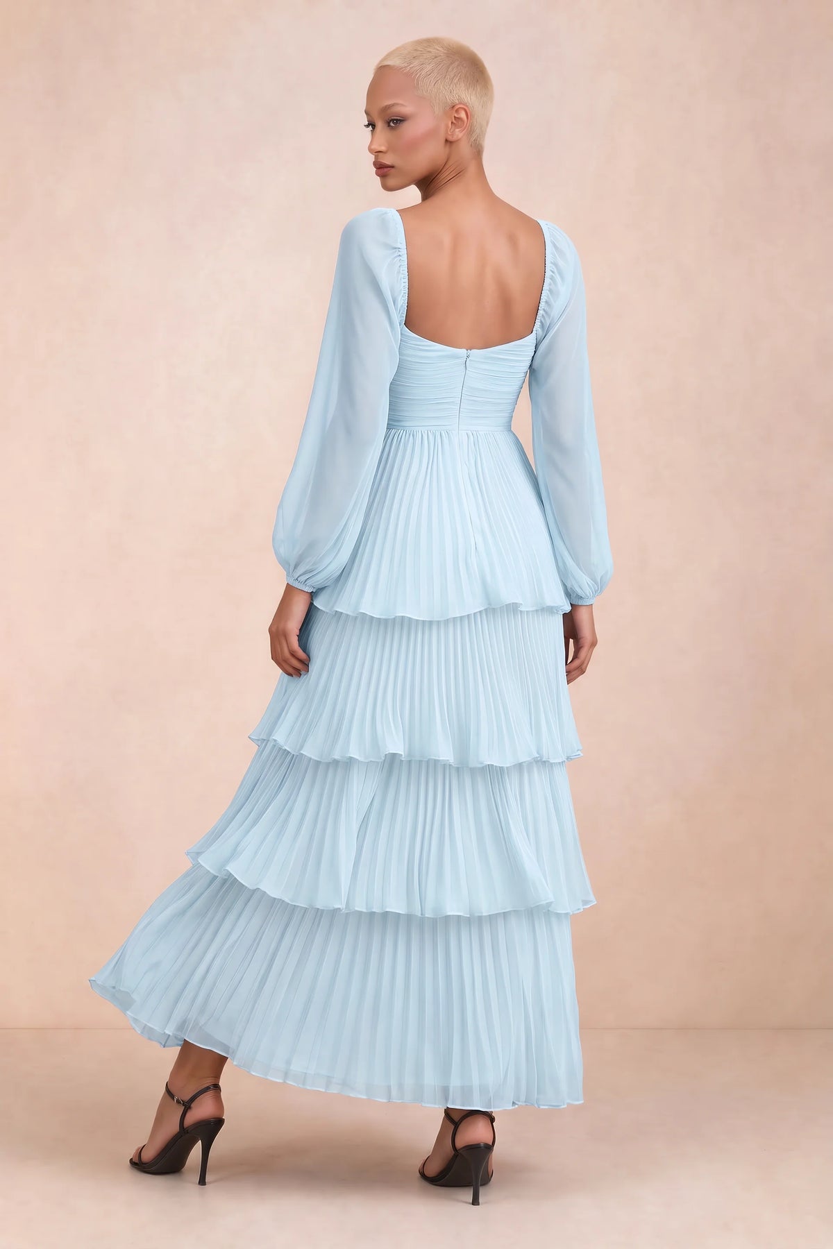 Rear studio view of Sienna sky blue tiered pleated maxi dress with a long flowing skirt