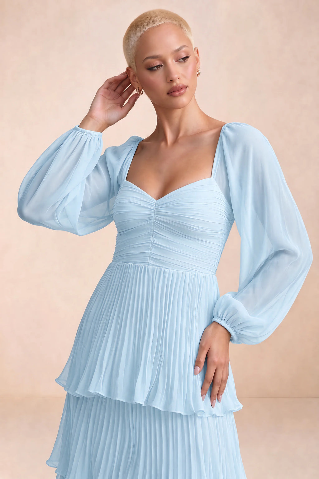 Close-up of sweetheart neckline, sheer sleeves and ruched waist of Sienna sky blue tiered pleated maxi dress
