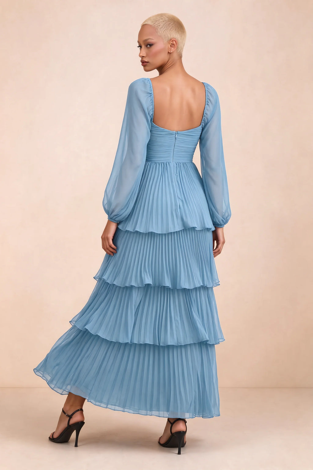 Rear studio view of Sienna steel blue tiered pleated maxi dress with a long flowing skirt