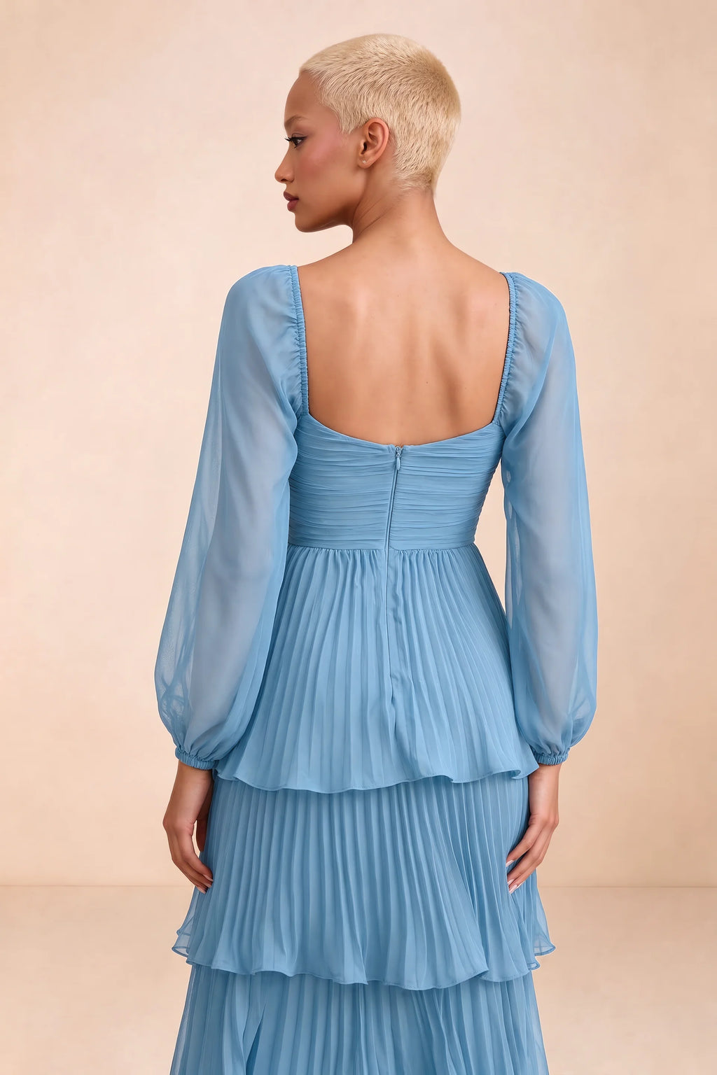 Close-up of low square back, sheer sleeves and centre-back zipper of Sienna steel blue tiered pleated maxi dress