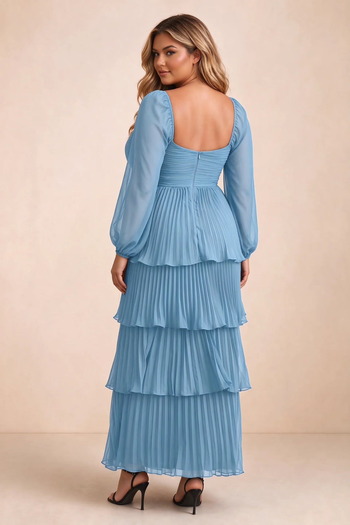 Rear view on a second model of Sienna steel blue tiered pleated maxi dress with a long flowing skirt