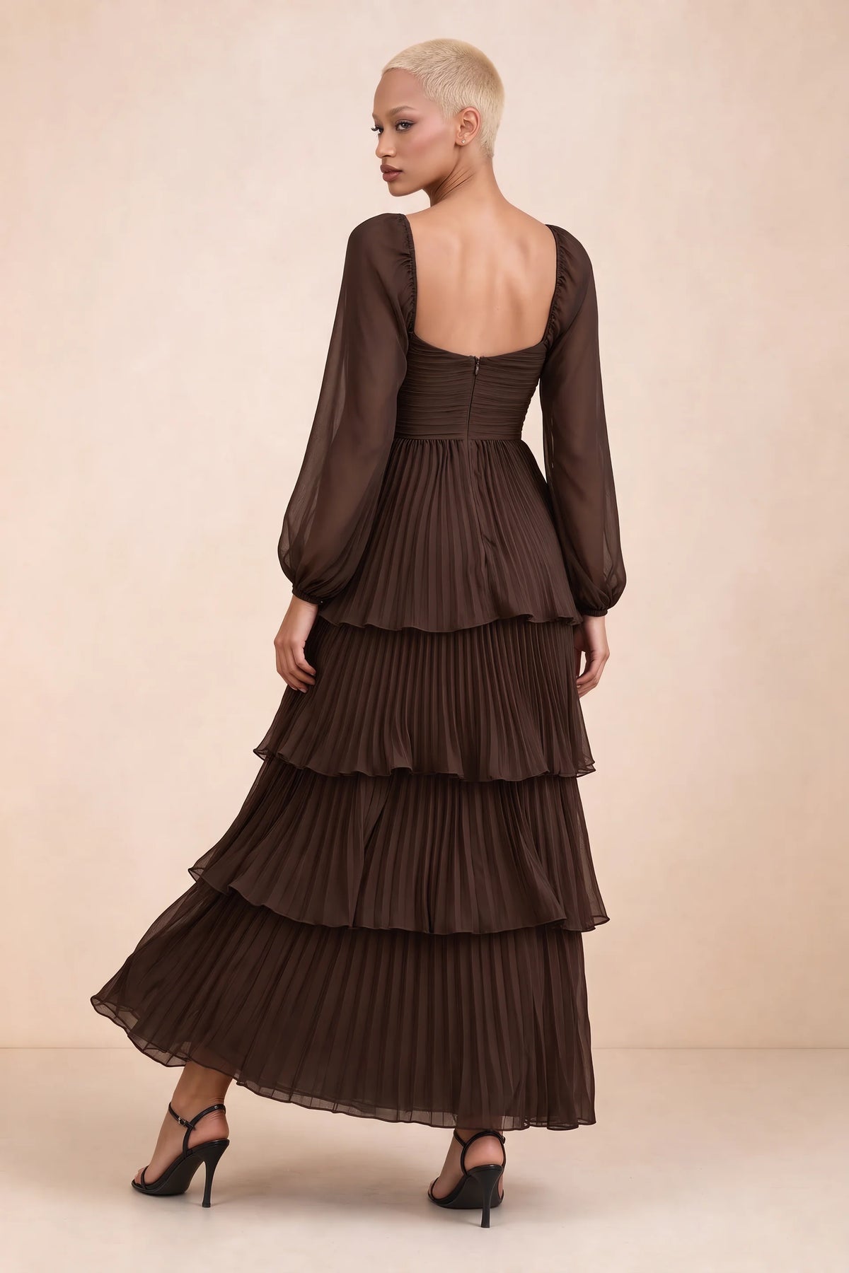 Rear studio view of Sienna truffle tiered pleated maxi dress with a long flowing skirt