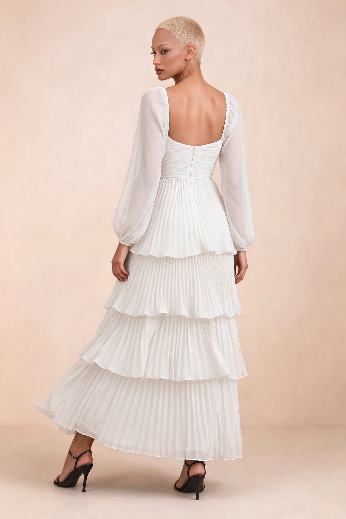 Rear studio view of Sienna white tiered pleated maxi dress with a long flowing skirt