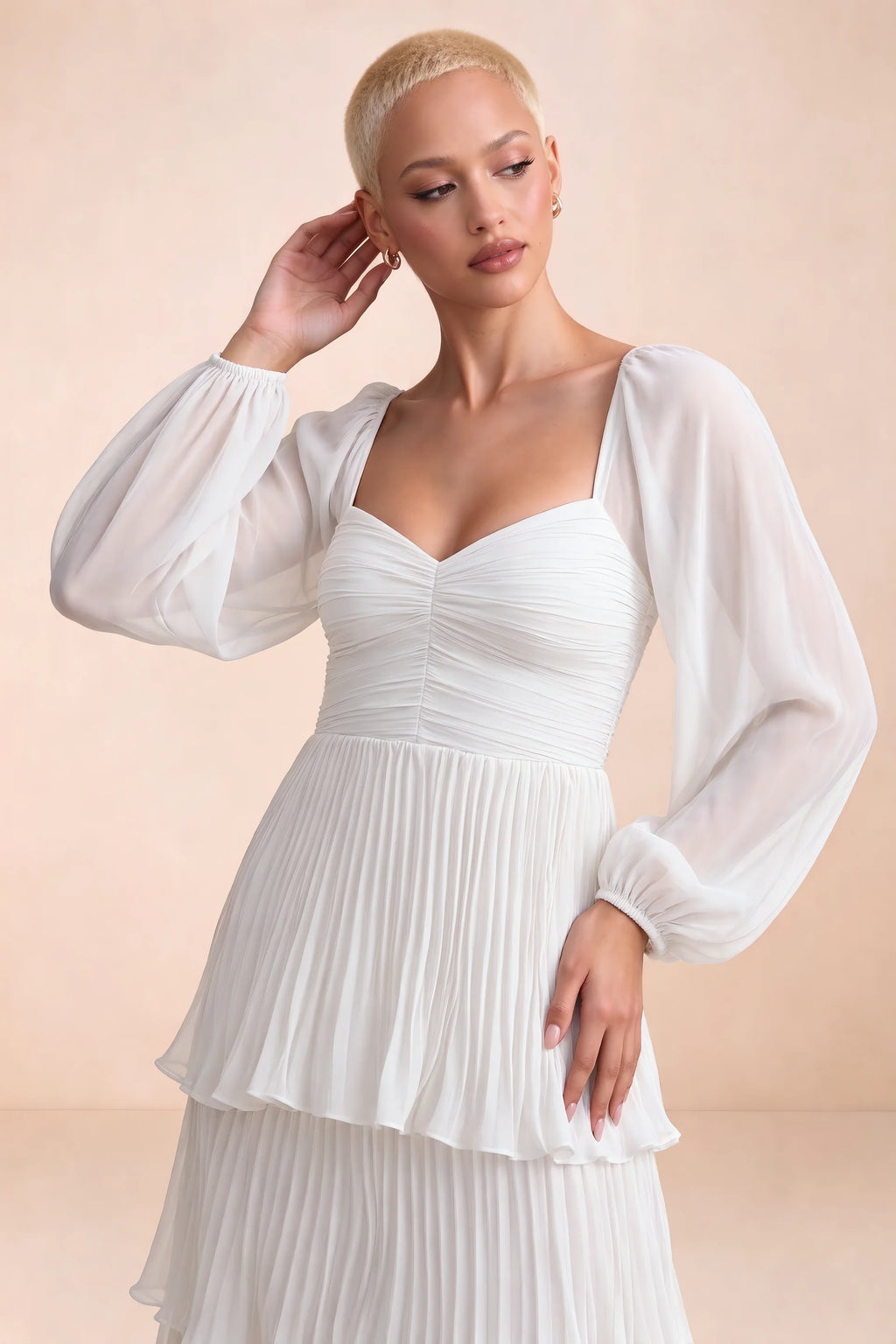 Close-up of sweetheart neckline, sheer sleeves and ruched waist of Sienna white tiered pleated maxi dress