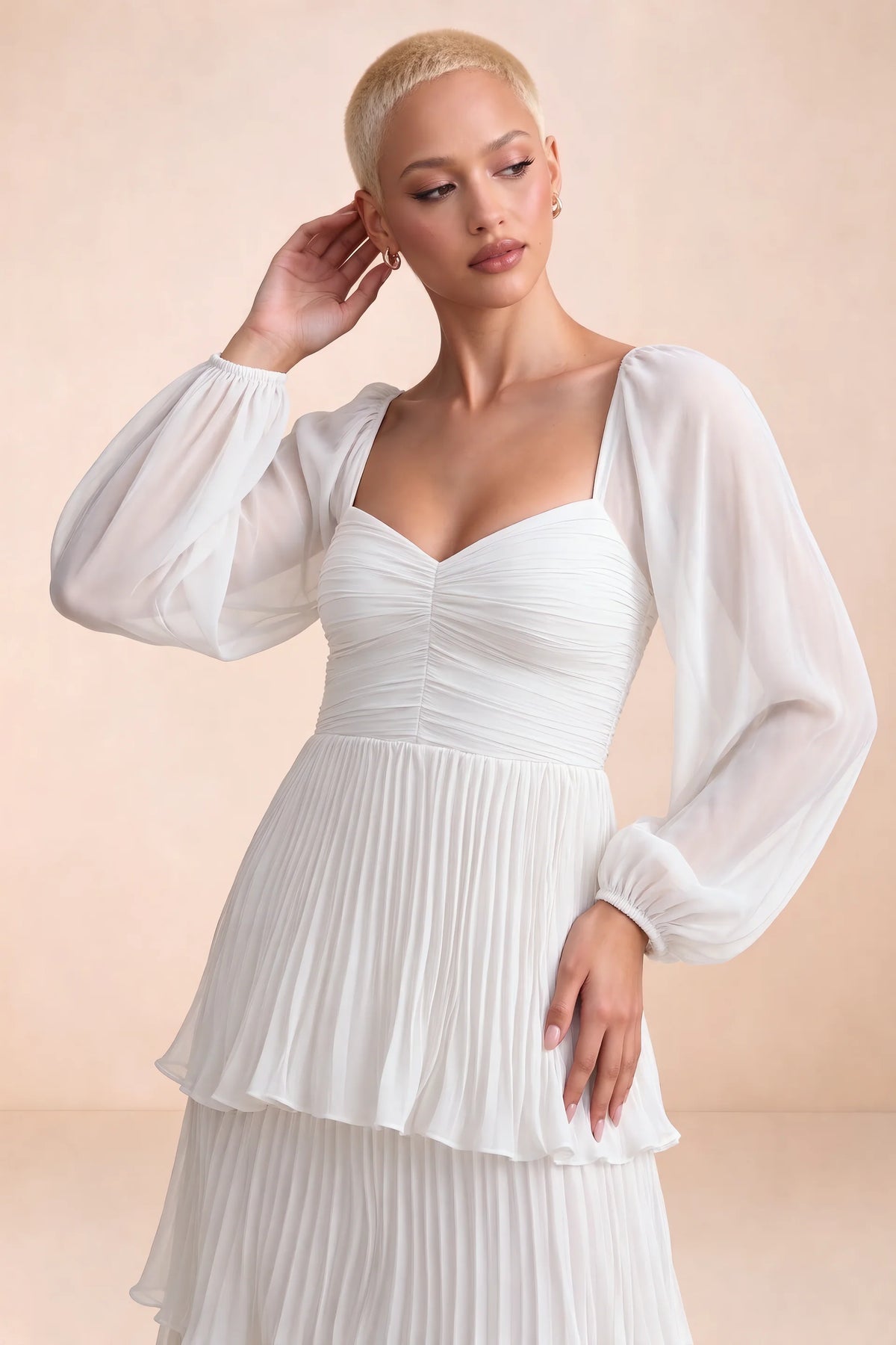 Close-up of sweetheart neckline, sheer sleeves and ruched waist of Sienna white tiered pleated maxi dress