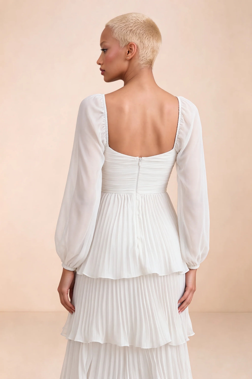 Close-up of low square back, sheer sleeves and centre-back zipper of Sienna white tiered pleated maxi dress