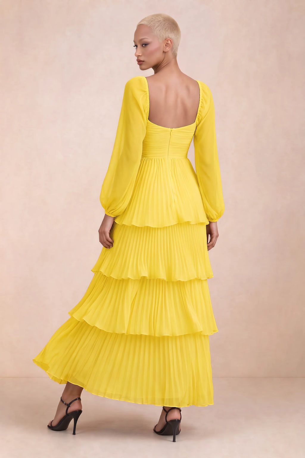 Rear studio view of Sienna yellow tiered pleated maxi dress with a long flowing skirt