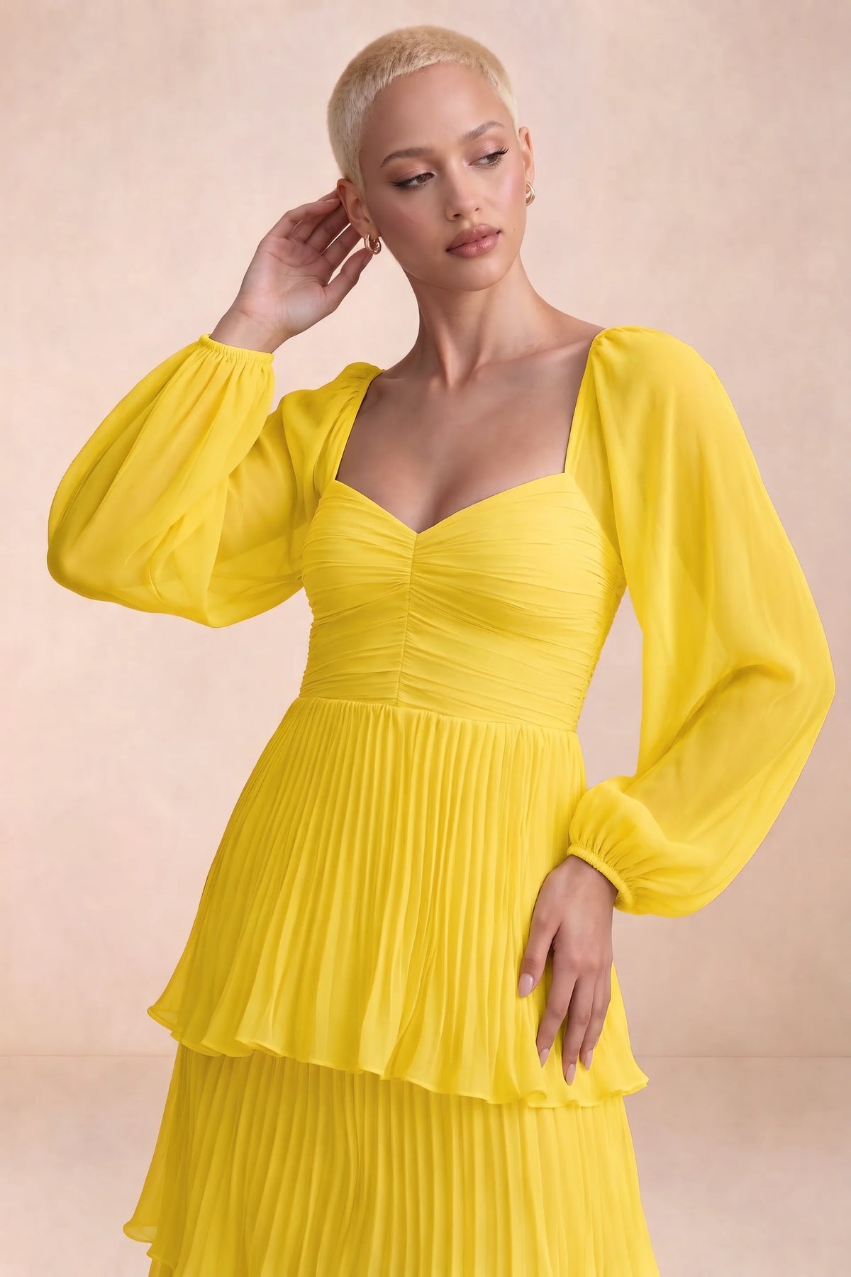 Close-up of sweetheart neckline, sheer sleeves and ruched waist of Sienna yellow tiered pleated maxi dress