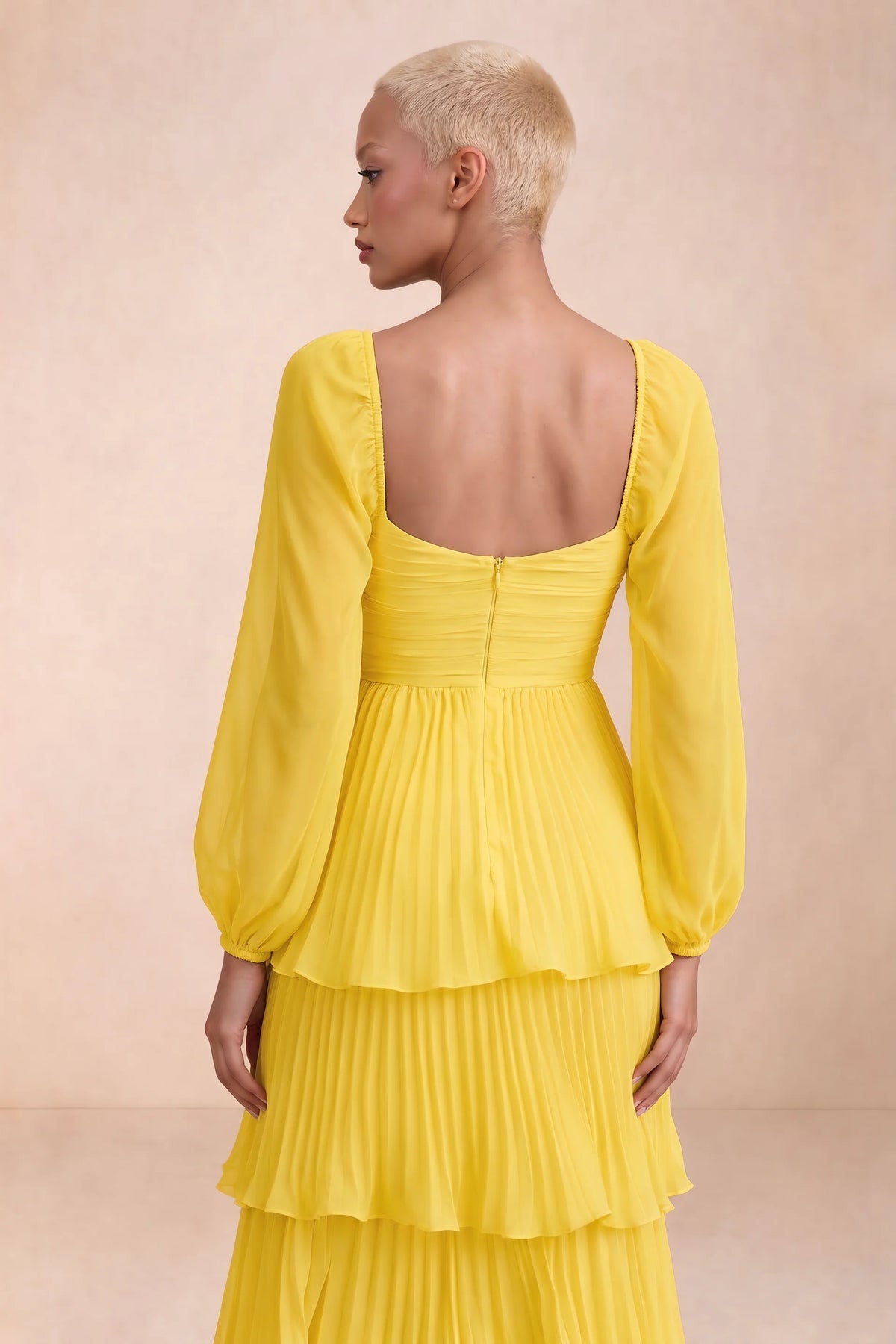 Close-up of low square back, sheer sleeves and centre-back zipper of Sienna yellow tiered pleated maxi dress