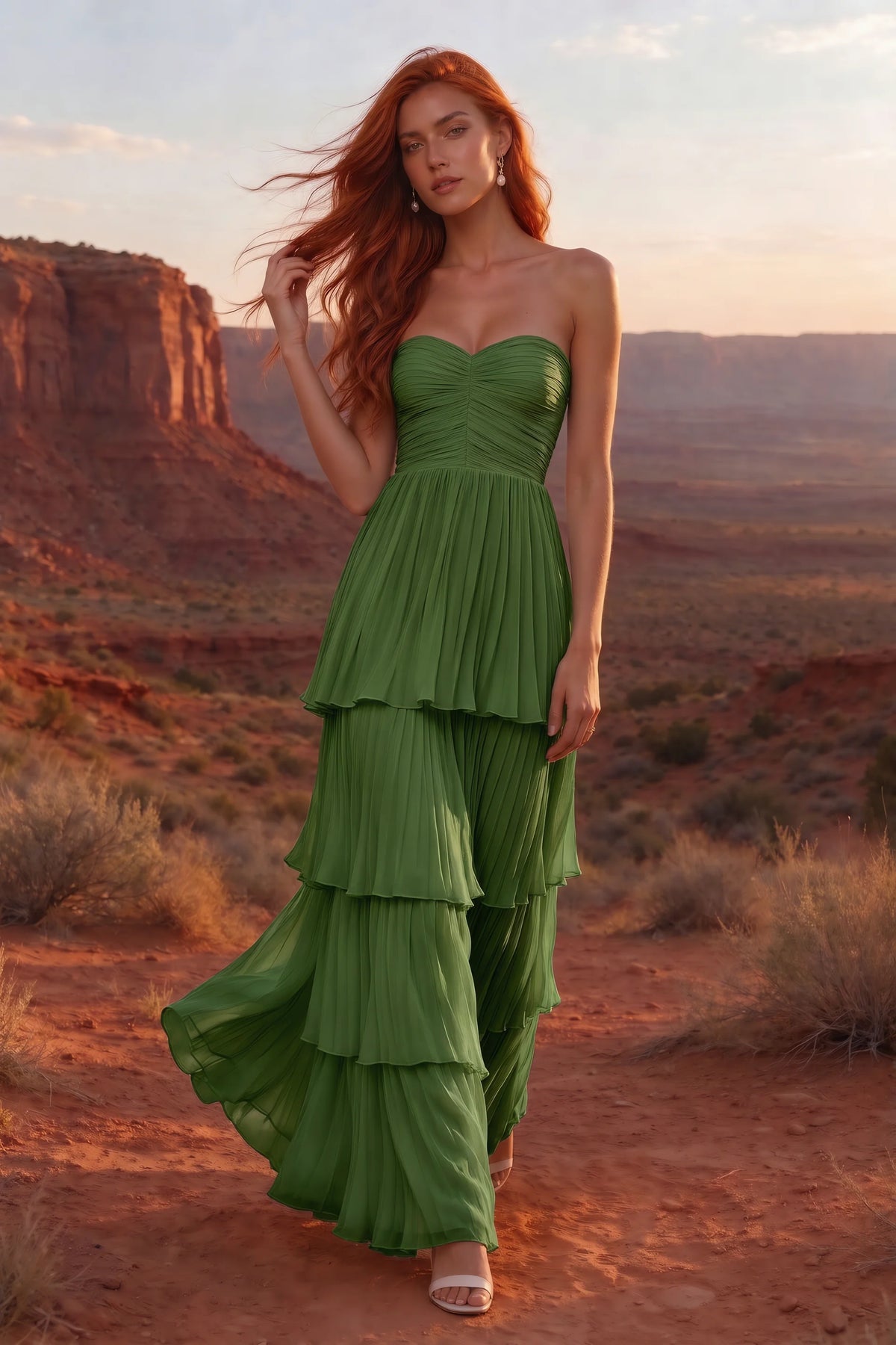 Outdoor front view in a desert canyon at sunset of Sonia basil tiered pleated maxi dress with a long flowing skirt