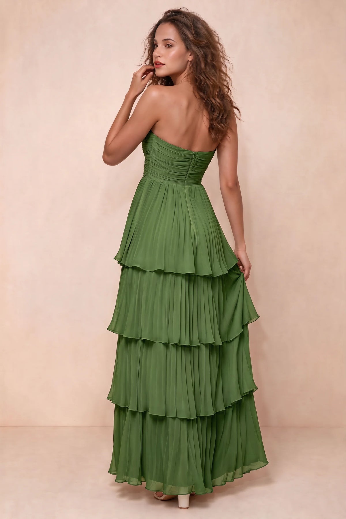 Rear studio view of Sonia basil tiered pleated maxi dress with a long flowing skirt