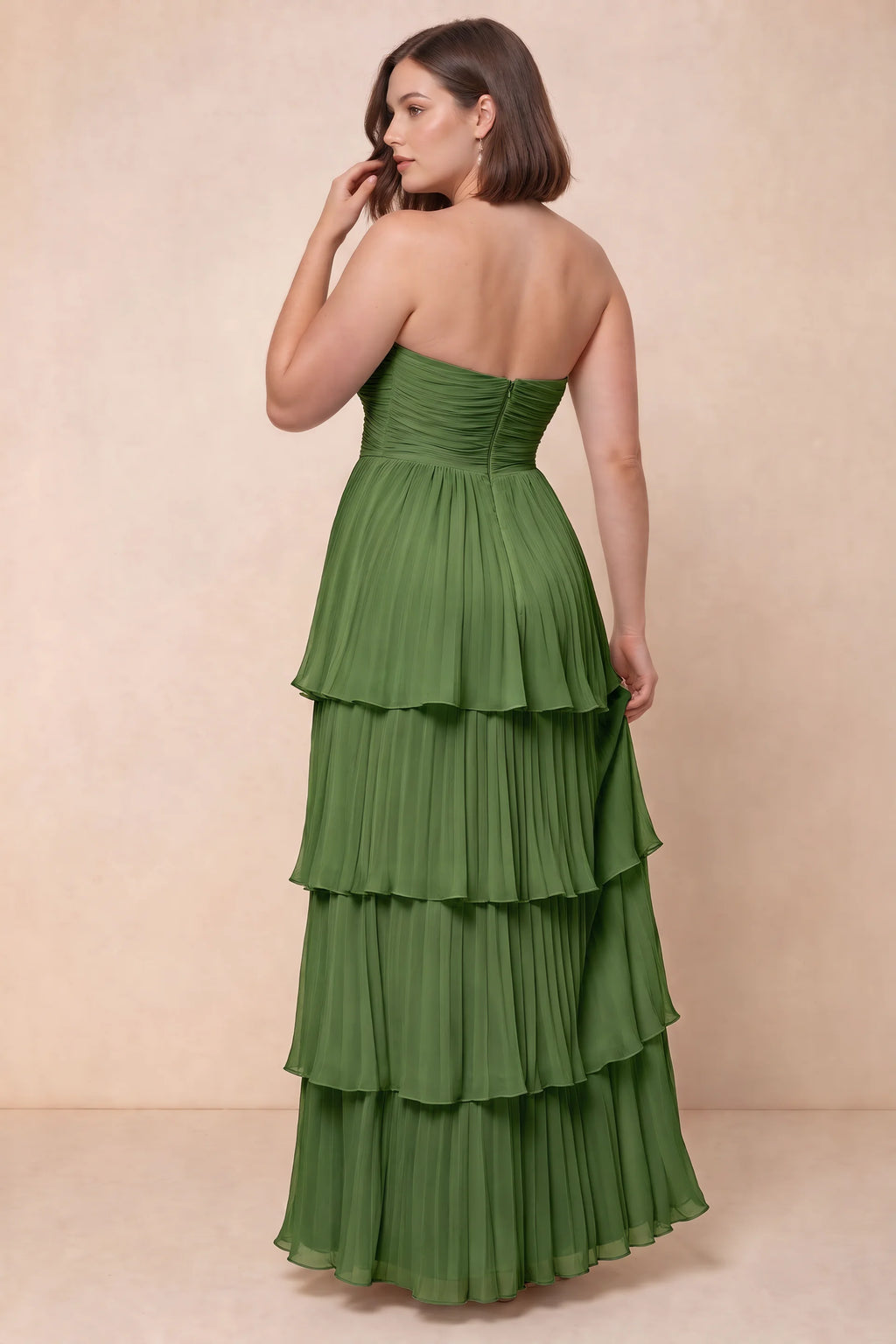 Rear view on a second model of Sonia basil tiered pleated maxi dress with a long flowing skirt
