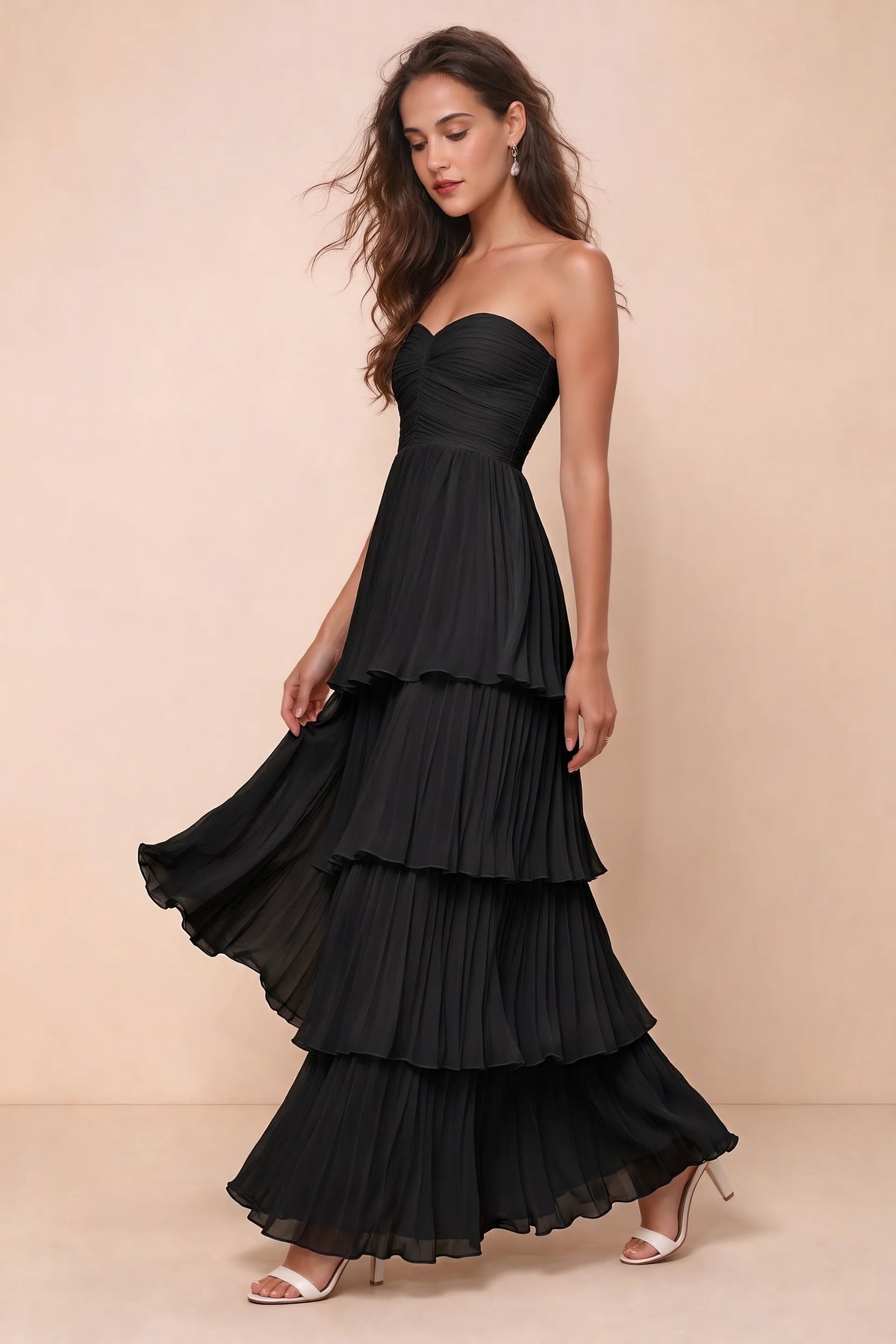 Front studio view of Sonia black tiered pleated maxi dress with a long flowing skirt