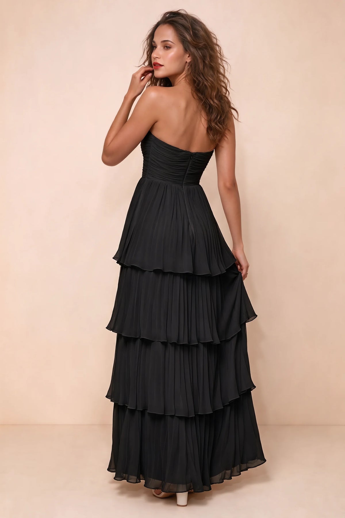 Rear studio view of Sonia black tiered pleated maxi dress with a long flowing skirt