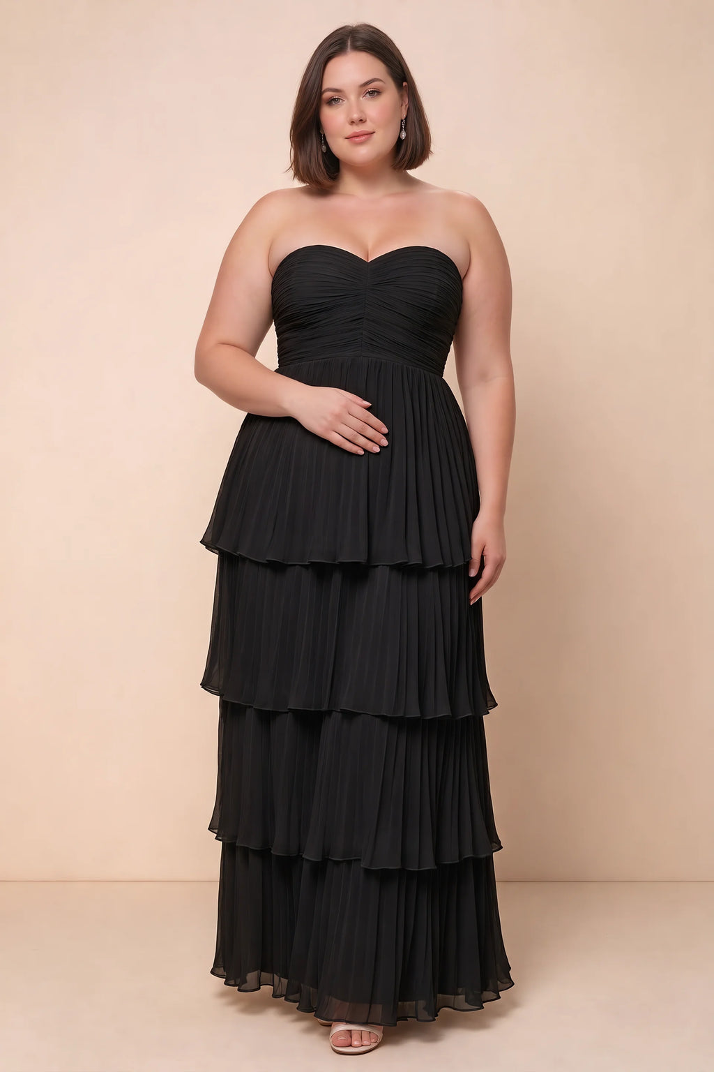 Front view on a second model of Sonia black tiered pleated maxi dress with a long flowing skirt