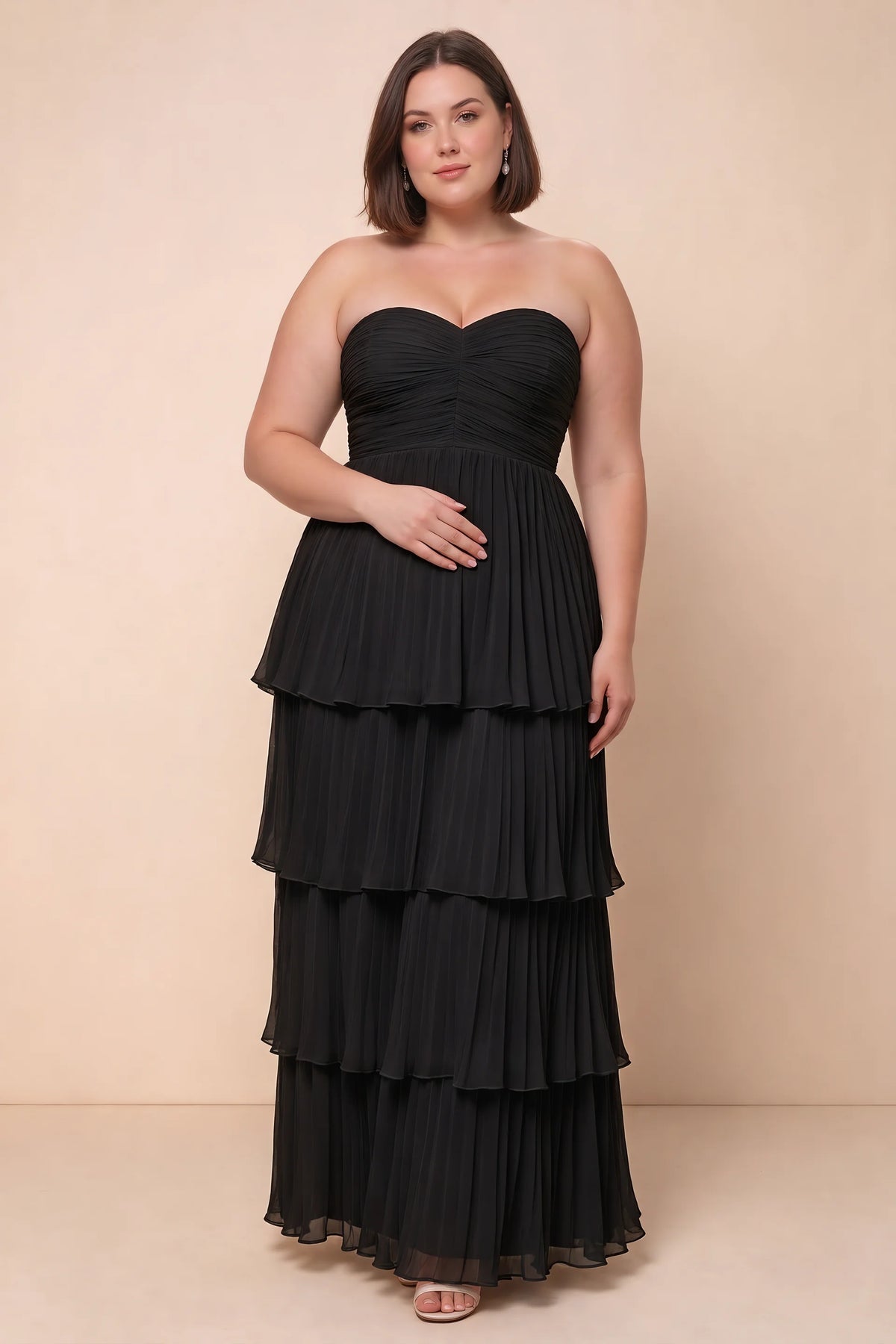 Front view on a second model of Sonia black tiered pleated maxi dress with a long flowing skirt
