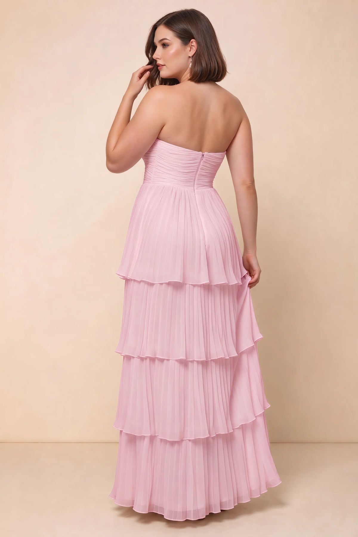 Rear view on a second model of Sonia candy pink tiered pleated maxi dress with a long flowing skirt