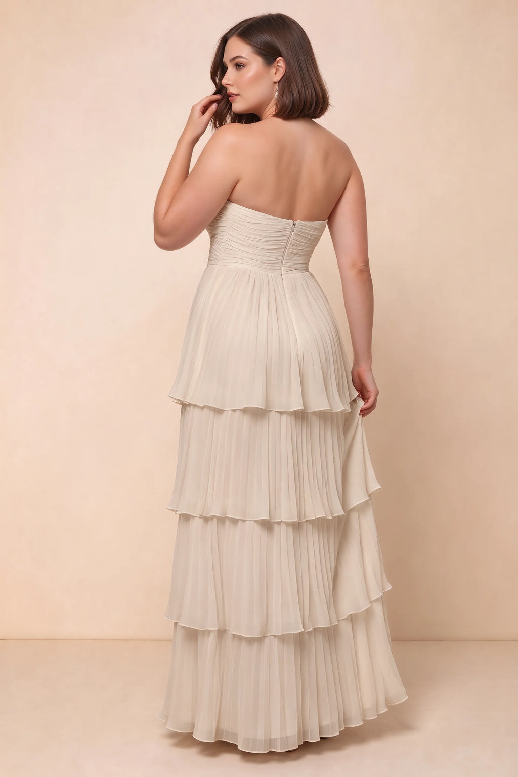 Rear view on a second model of Sonia cream tiered pleated maxi dress with a long flowing skirt