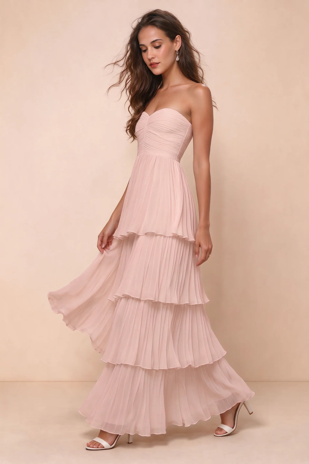 Front studio view of Sonia haze pink tiered pleated maxi dress with a long flowing skirt