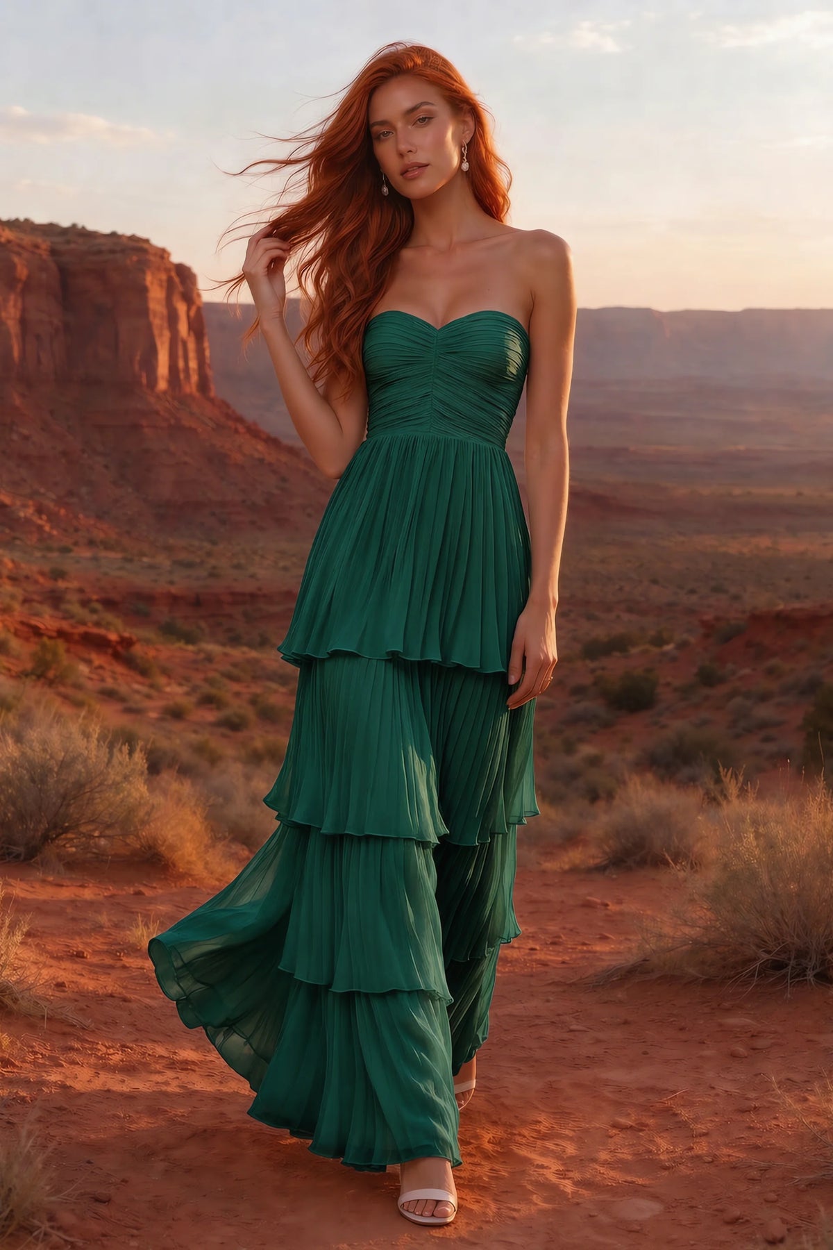 Outdoor front view in a desert canyon at sunset of Sonia hunter green tiered pleated maxi dress with a long flowing skirt