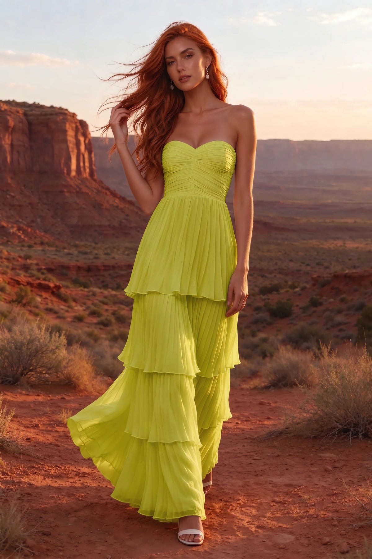 Outdoor front view in a desert canyon at sunset of Sonia lemon green tiered pleated maxi dress with a long flowing skirt