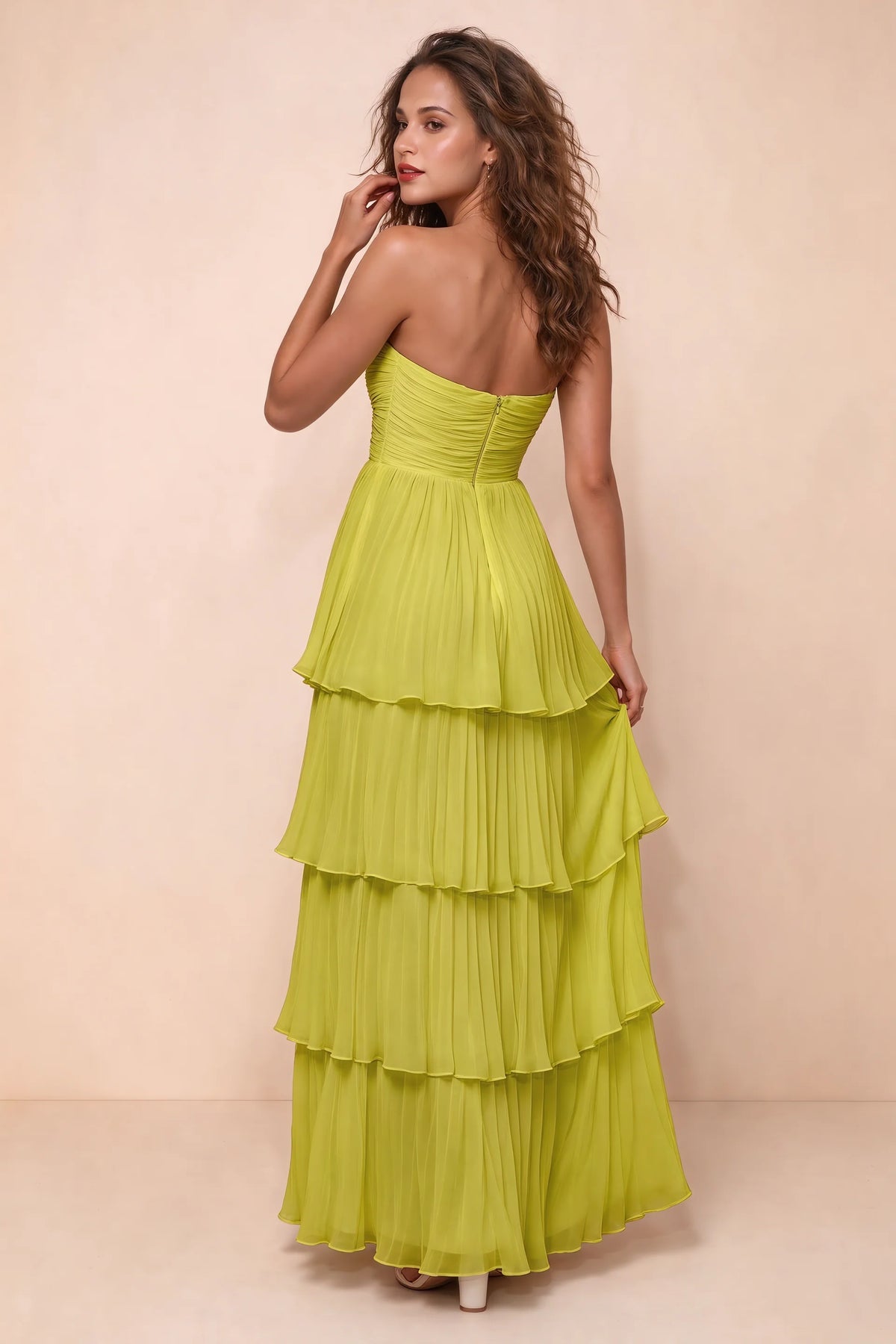 Rear studio view of Sonia lemon green tiered pleated maxi dress with a long flowing skirt