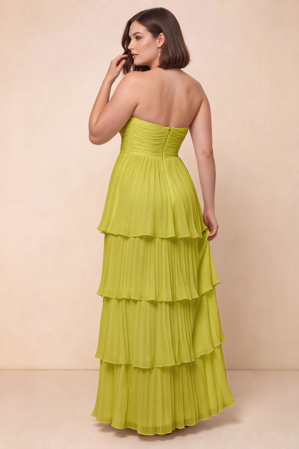 Rear view on a second model of Sonia lemon green tiered pleated maxi dress with a long flowing skirt