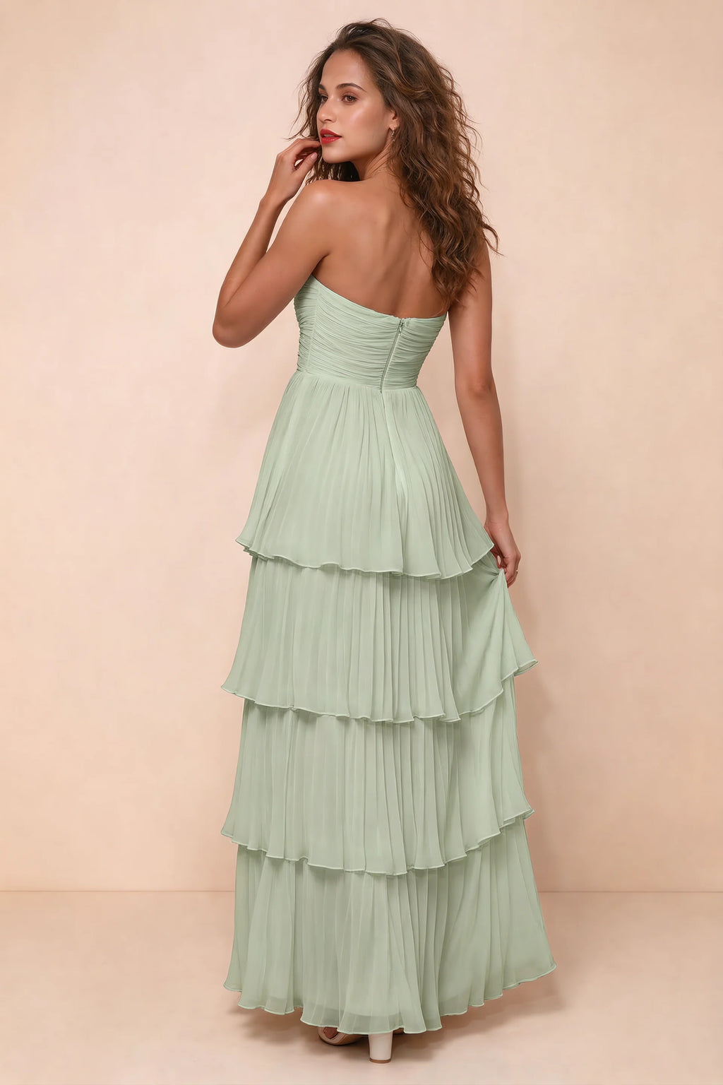 Rear studio view of Sonia light green tiered pleated maxi dress with a long flowing skirt