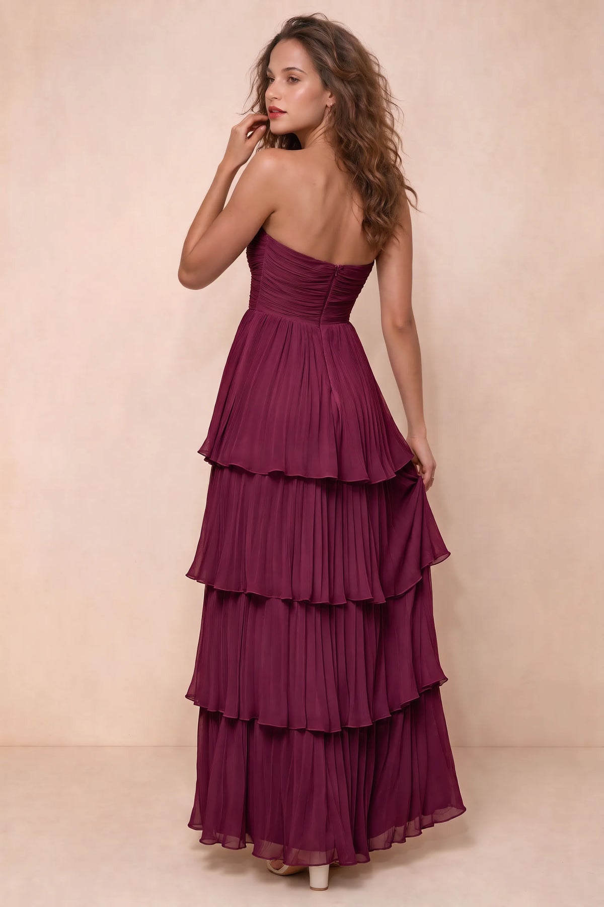 Rear studio view of Sonia merlot tiered pleated maxi dress with a long flowing skirt