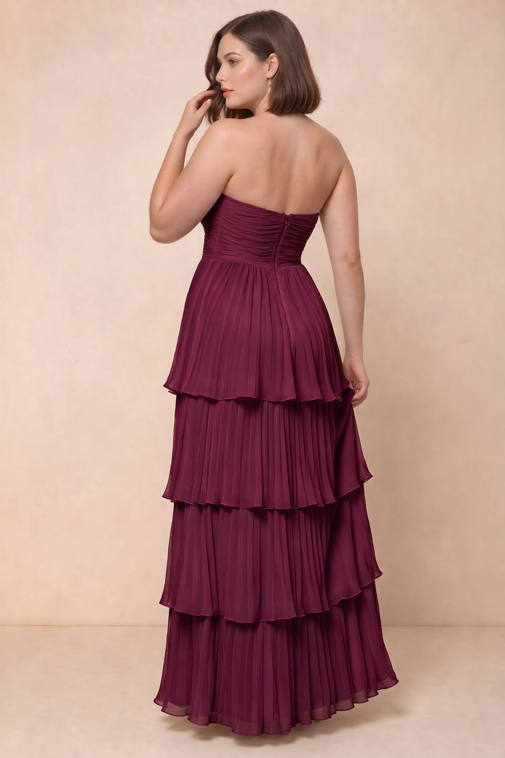 Rear view on a second model of Sonia merlot tiered pleated maxi dress with a long flowing skirt