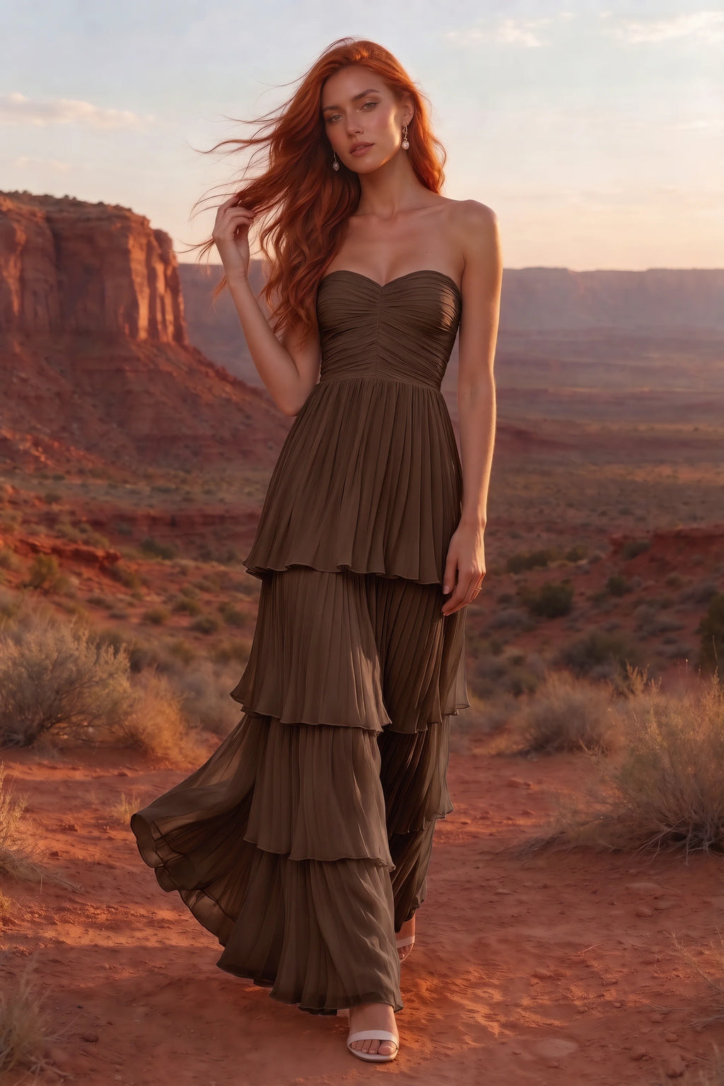Outdoor front view in a desert canyon at sunset of Sonia mocha tiered pleated maxi dress with a long flowing skirt
