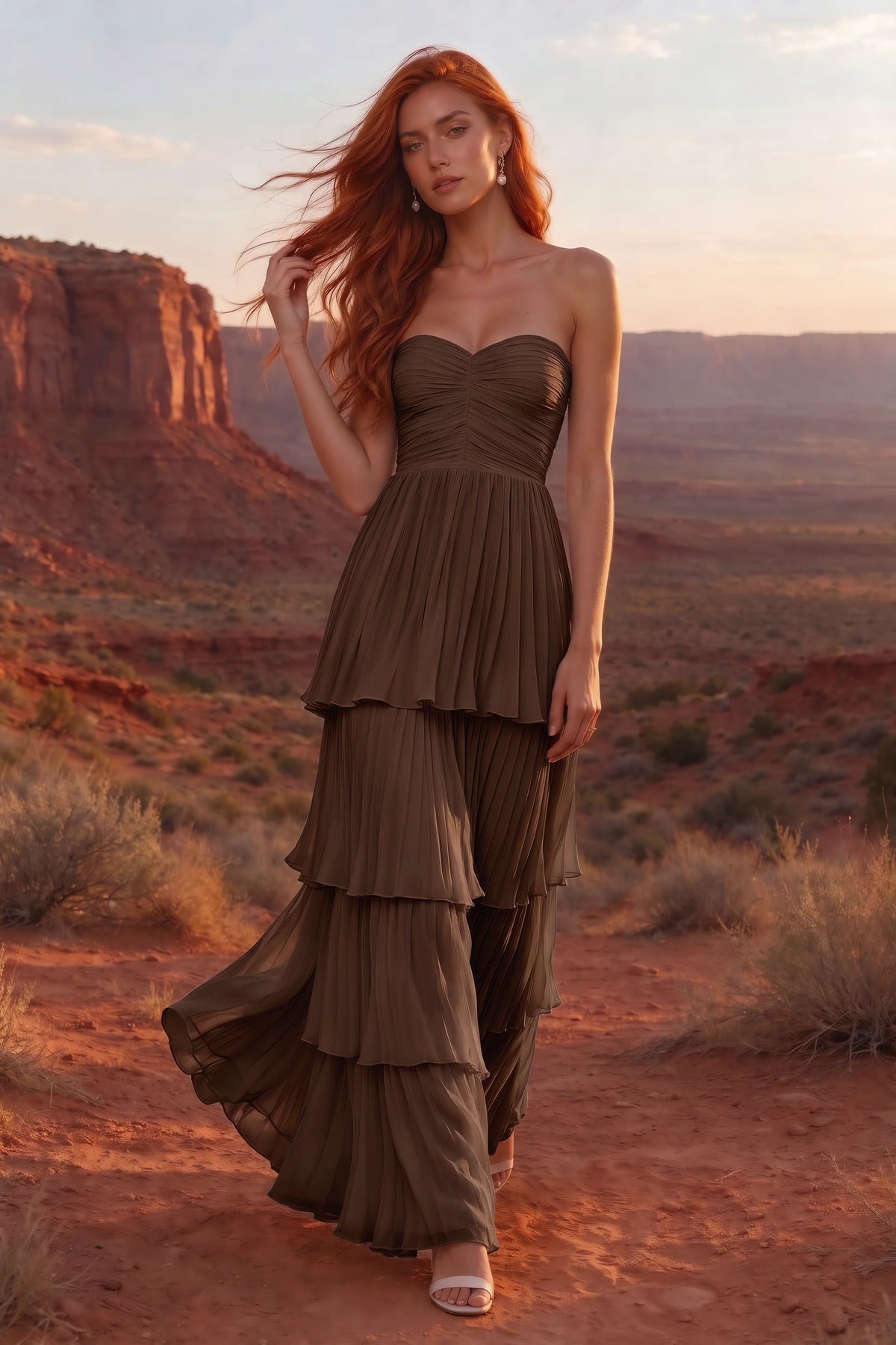 Outdoor front view in a desert canyon at sunset of Sonia mocha tiered pleated maxi dress with a long flowing skirt