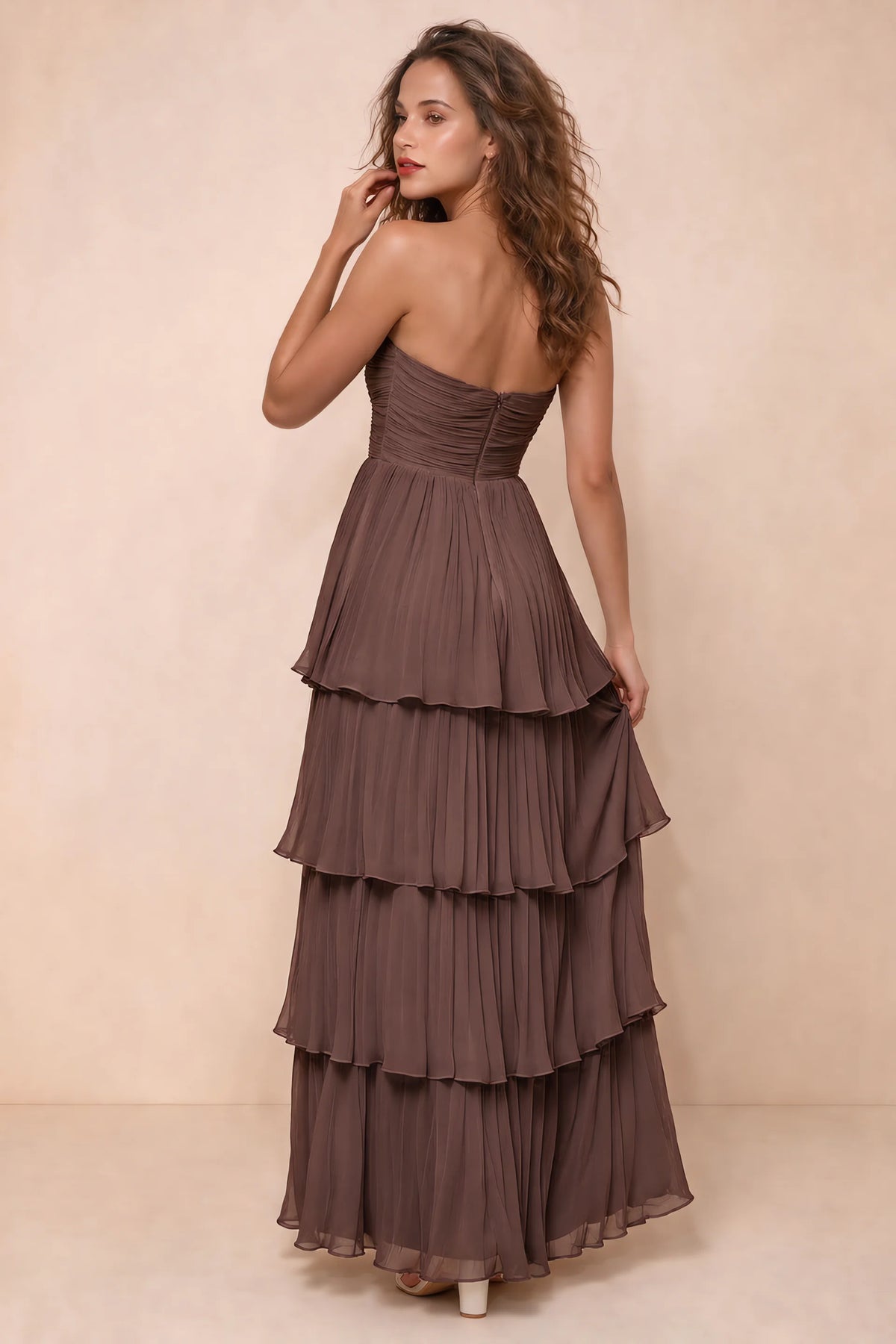 Rear studio view of Sonia mocha tiered pleated maxi dress with a long flowing skirt