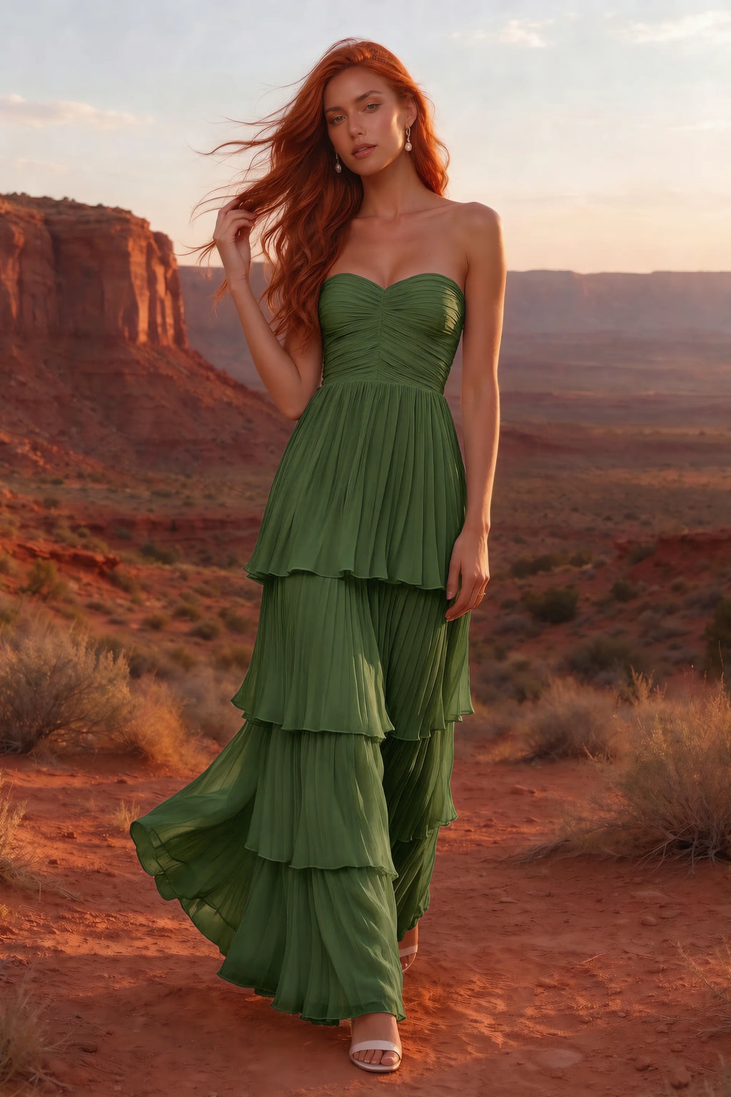 Outdoor front view in a desert canyon at sunset of Sonia olive green tiered pleated maxi dress with a long flowing skirt